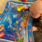 Alfombra sensorial de agua para bebés